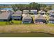 Backyard aerial view featuring a screened-in pool and picturesque water view at 8935 Sonoma Coast Dr, Winter Garden, FL 34787