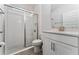 This bright bathroom features a glass enclosed shower, tile floor, and modern vanity at 8935 Sonoma Coast Dr, Winter Garden, FL 34787