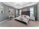 Elegant bedroom with tray ceiling, gray walls, cozy decor, and natural light from the windows at 8935 Sonoma Coast Dr, Winter Garden, FL 34787