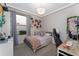 Cozy bedroom features a comfortable bed, built-in shelving and desk area at 8935 Sonoma Coast Dr, Winter Garden, FL 34787