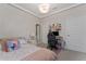 Comfortable bedroom features a bed, desk, and ample natural light at 8935 Sonoma Coast Dr, Winter Garden, FL 34787
