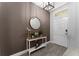 Inviting entryway featuring tile floors, decorative table, and mirror at 8935 Sonoma Coast Dr, Winter Garden, FL 34787