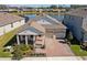 Beautiful exterior view of home with brick driveway, lake view, well-kept lawn, and two-car garage at 8935 Sonoma Coast Dr, Winter Garden, FL 34787