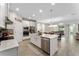 Bright open kitchen with white cabinets, stainless steel appliances, a large kitchen island and an open concept layout at 8935 Sonoma Coast Dr, Winter Garden, FL 34787