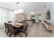 Open-concept living and dining area with light gray walls, tile floors, and contemporary furnishings at 8935 Sonoma Coast Dr, Winter Garden, FL 34787