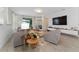Living area featuring modern decor, a large sofa, stylish tables, and a view to the lanai at 8935 Sonoma Coast Dr, Winter Garden, FL 34787