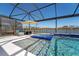 Relax in this screened-in pool with a tanning ledge, spill-over spa, and lake views at 8935 Sonoma Coast Dr, Winter Garden, FL 34787