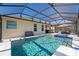 View of the screened-in pool featuring a tanning ledge and spill-over spa at 8935 Sonoma Coast Dr, Winter Garden, FL 34787