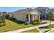 Home's exterior featuring a well-manicured lawn and partially covered patio area with nice greenery at 8935 Sonoma Coast Dr, Winter Garden, FL 34787