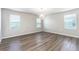 Bedroom featuring wood-look floor, a modern light fixture, and natural light at 1024 Desert Candle Dr, Ocoee, FL 34761