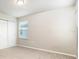 Cozy bedroom with carpet flooring, a closet, and natural light from the window at 1024 Desert Candle Dr, Ocoee, FL 34761