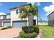Inviting townhouse with brick driveway, lush landscaping, and a two-car garage, offering curb appeal and convenience at 1024 Desert Candle Dr, Ocoee, FL 34761