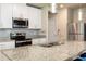 Bright kitchen featuring stainless steel appliances, granite countertops, subway tile backsplash, and a convenient kitchen island at 1024 Desert Candle Dr, Ocoee, FL 34761