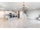 Open-concept living space with a decorative chandelier, stylish kitchen and a seamless transition to the living area at 1024 Desert Candle Dr, Ocoee, FL 34761