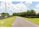 Paved walking path alongside a fenced community at 1024 Desert Candle Dr, Ocoee, FL 34761