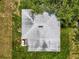 Aerial view showcases the home's roof with a unique shingle design, along with the surrounding green landscape at 105 N Florida Ave, Howey In The Hills, FL 34737