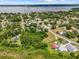 Comprehensive aerial view of the neighborhood, highlighting its proximity to a lake and dense tree coverage at 105 N Florida Ave, Howey In The Hills, FL 34737
