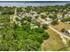 Aerial view of neighborhood with tree coverage and lake background at 105 N Florida Ave, Howey In The Hills, FL 34737