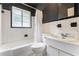 Classic bathroom featuring a shower-tub combo and pedestal sink at 105 N Florida Ave, Howey In The Hills, FL 34737