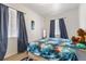 Comfortable bedroom with a soft rug and natural light from two windows at 105 N Florida Ave, Howey In The Hills, FL 34737