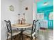 Cozy dining area with a round table and chairs, adjacent to the kitchen, perfect for intimate meals at 105 N Florida Ave, Howey In The Hills, FL 34737