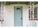 Close-up of the home's front door featuring decorative details at 105 N Florida Ave, Howey In The Hills, FL 34737