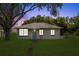 Charming single-story home with a well-maintained lawn and mature trees at 105 N Florida Ave, Howey In The Hills, FL 34737