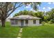 Charming single story home with lush green lawn and mature shade tree at 105 N Florida Ave, Howey In The Hills, FL 34737