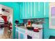 Compact kitchen features brightly painted cabinets, tiled backsplash, and essential appliances for cooking at 105 N Florida Ave, Howey In The Hills, FL 34737