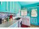 Unique blue kitchen with vintage cabinets and ample counter space at 105 N Florida Ave, Howey In The Hills, FL 34737
