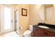 This bathroom features a vanity with a dark wood finish and a shower and toilet at 1156 Castle Pines Ct, Reunion, FL 34747