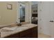 This bathroom features a granite vanity, mirror and entry ways to two bedrooms in the home at 1156 Castle Pines Ct, Reunion, FL 34747