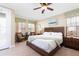 The bedroom features a bed with white bedding, an accent chair and a door to the exterior at 1156 Castle Pines Ct, Reunion, FL 34747