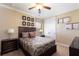 The bedroom features a ceiling fan and closet with decorative art and neutral walls at 1156 Castle Pines Ct, Reunion, FL 34747