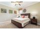 Cozy bedroom with neutral carpet, ceiling fan, and an inviting queen-sized bed at 1156 Castle Pines Ct, Reunion, FL 34747