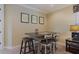 This stylish dining area has seating for four, along with neutral décor and simple framed art at 1156 Castle Pines Ct, Reunion, FL 34747
