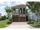 Elegant two-story home with a tile roof, stucco exterior, and beautifully landscaped yard at 1156 Castle Pines Ct, Reunion, FL 34747