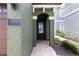 Charming front door with decorative stone walkway and well-manicured landscaping at 1156 Castle Pines Ct, Reunion, FL 34747
