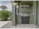 Outdoor kitchen with a stainless steel grill, counter space, storage and beautiful outdoor setting at 1156 Castle Pines Ct, Reunion, FL 34747