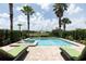 Beautiful pool and jacuzzi with palm trees, lounge chairs, and lush landscaping, perfect for relaxation at 1156 Castle Pines Ct, Reunion, FL 34747