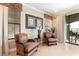 Cozy sitting area with comfortable wicker chairs, natural light, and view of the outdoor patio at 1156 Castle Pines Ct, Reunion, FL 34747