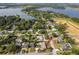 Aerial shot of a home near a lake, highlighted with a red arrow, featuring a private pool and lush surroundings at 1301 Fahnstock St, Eustis, FL 32726
