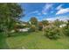 Lush backyard with a pool, mature trees, and green lawn, ideal for outdoor activities at 1301 Fahnstock St, Eustis, FL 32726