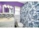 Colorful bathroom features a modern sink, toilet, and shower with a patterned curtain at 1301 Fahnstock St, Eustis, FL 32726