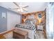 Bedroom features a decorative wood accent wall, closet, ceiling fan and natural light at 1301 Fahnstock St, Eustis, FL 32726
