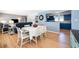 Open-concept dining room with hardwood floors, connecting the living area and kitchen at 1301 Fahnstock St, Eustis, FL 32726