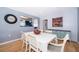 Dining area with hardwood floors, featuring a view into the kitchen, and bright natural light at 1301 Fahnstock St, Eustis, FL 32726
