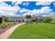 Charming ranch-style home with a well-manicured lawn, brick walkway, and a bright turquoise front door at 1301 Fahnstock St, Eustis, FL 32726