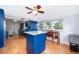 Eat-in kitchen features blue cabinets, an island, and lots of natural light from surrounding windows at 1301 Fahnstock St, Eustis, FL 32726