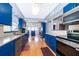 Modern kitchen features stainless steel appliances, granite countertops, and sleek blue cabinetry at 1301 Fahnstock St, Eustis, FL 32726